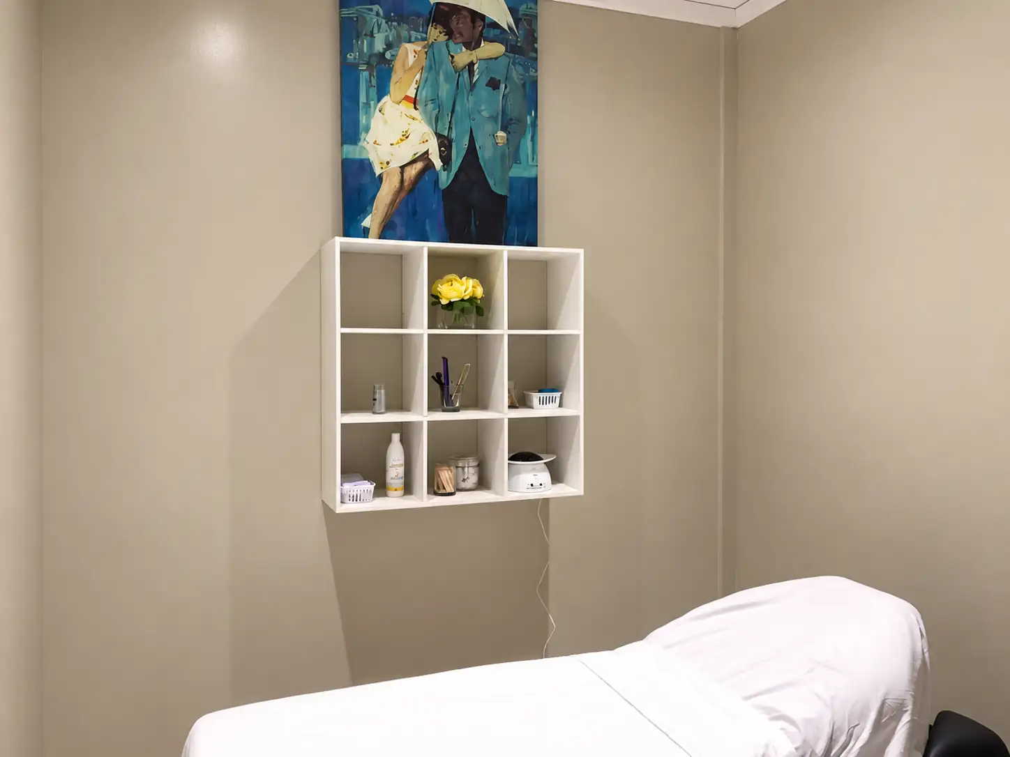 Waxing room at Allure with a treatment bed and product shelves