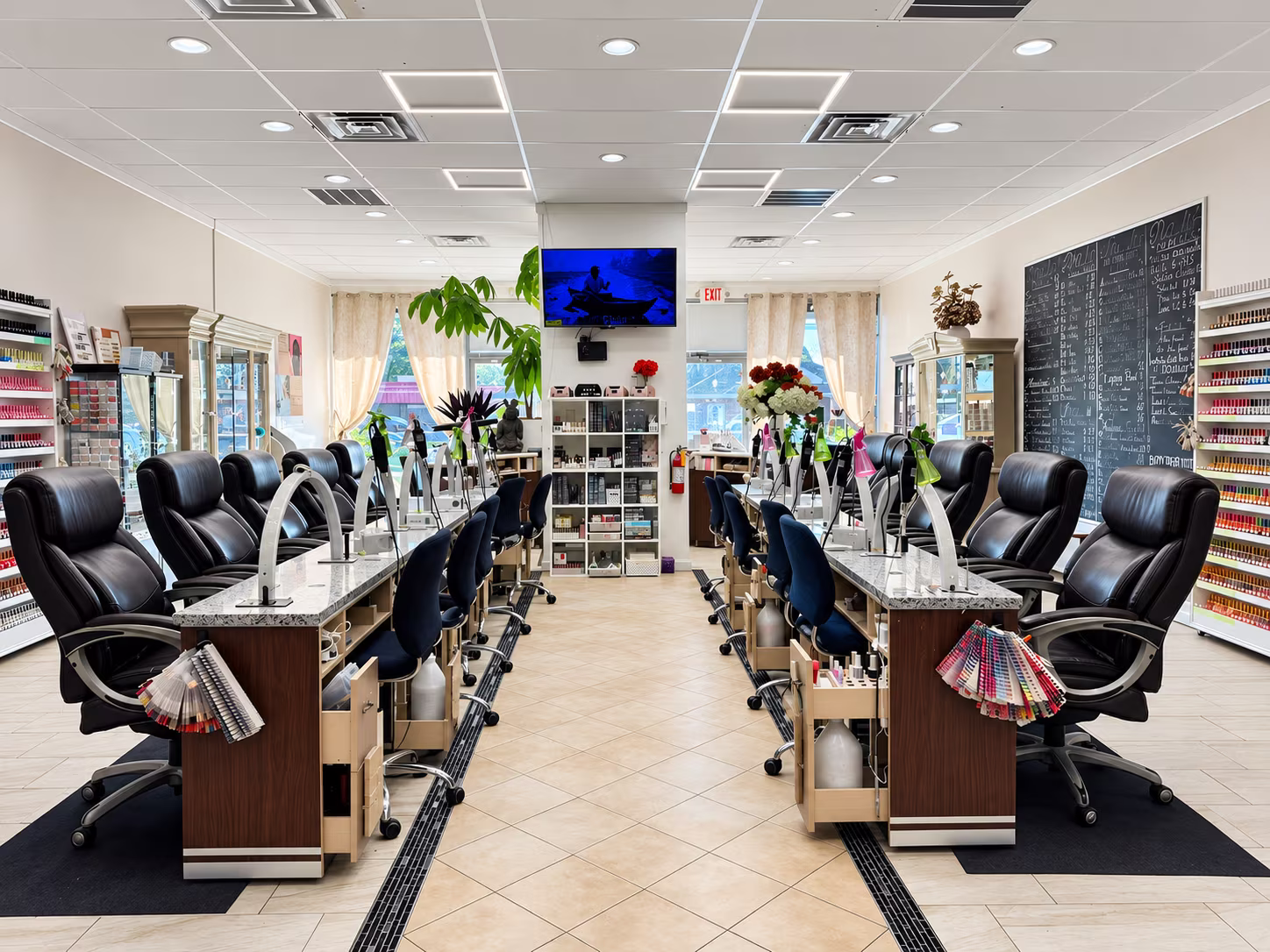 Manicure stations at Allure Nails with leather chairs and nail tables