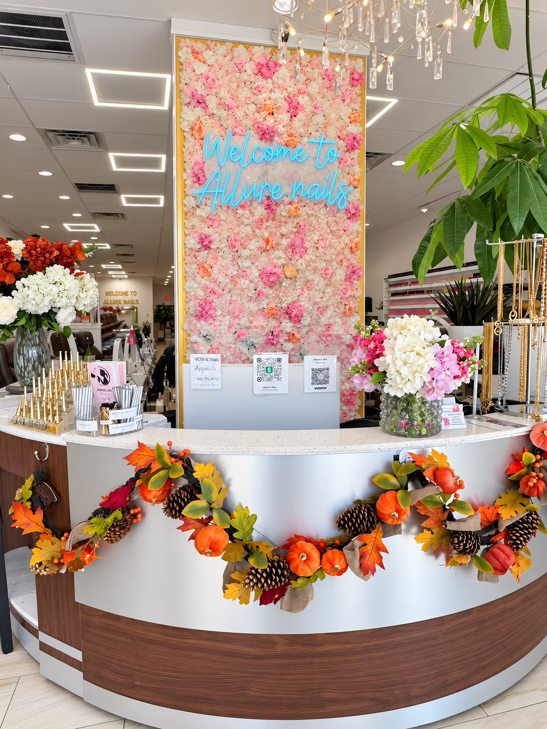 Front desk and flower wall at Allure Nails & Beauty