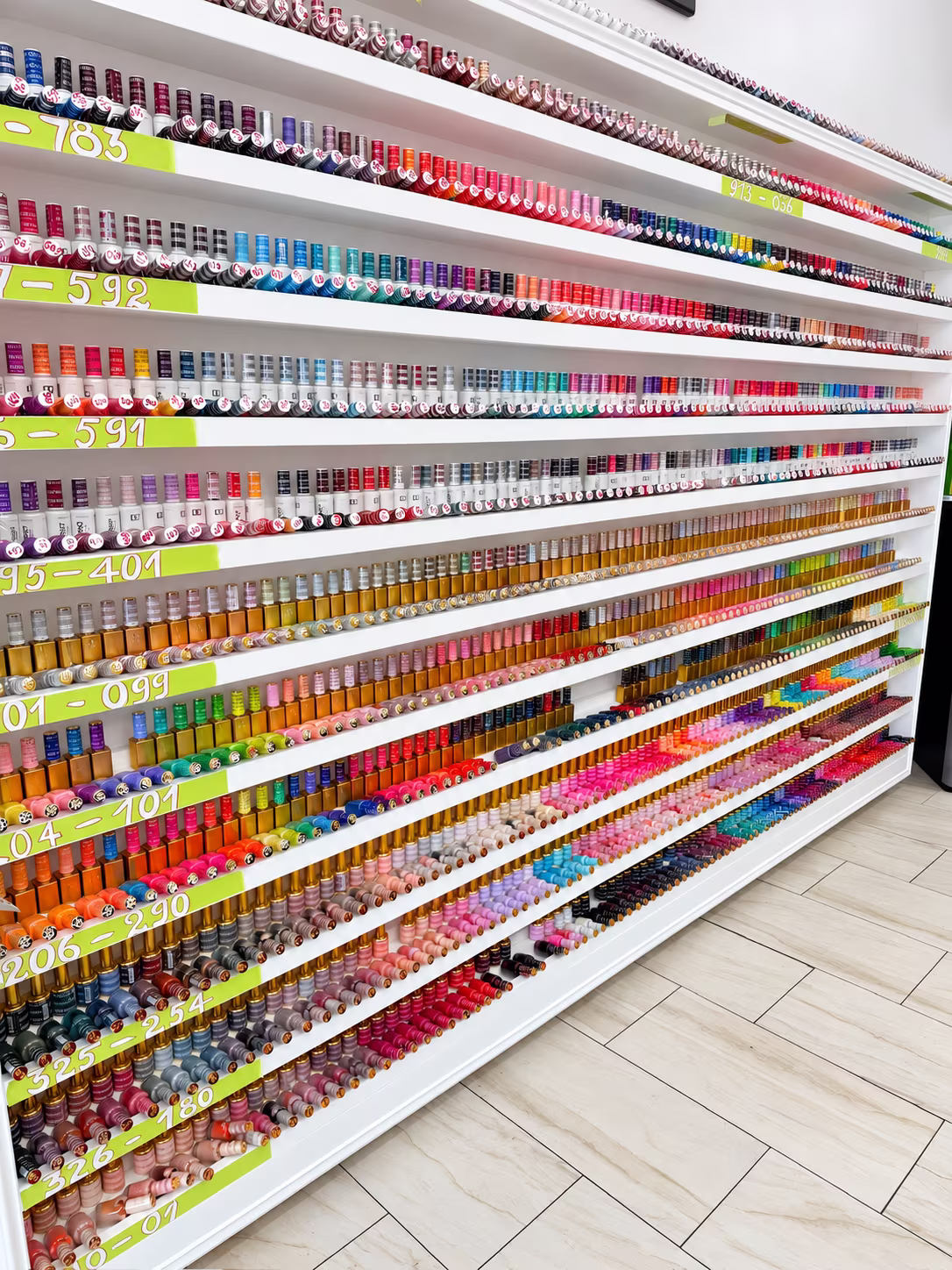 Long wall of nail polish and gel colors at Allure Nails